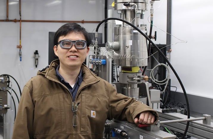 Headshot of Yi Fang in the lab wearing safety glasses.